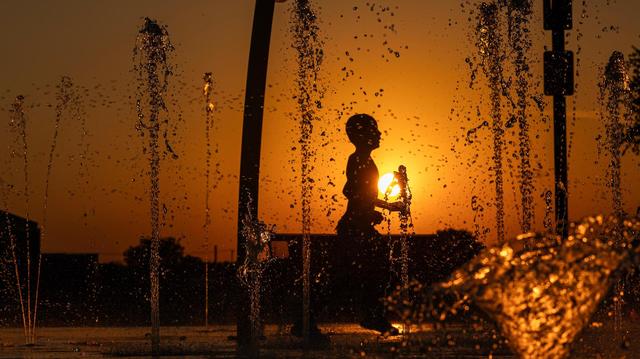 Emmanuel Salazar, 7, runs through the water on the Watauga Splash Pad at Capp Smith Park in Watauga on Thursday, June 27, 2024.Temperatures rose to over 100 degrees as the summer heatwave begins to heat up.
